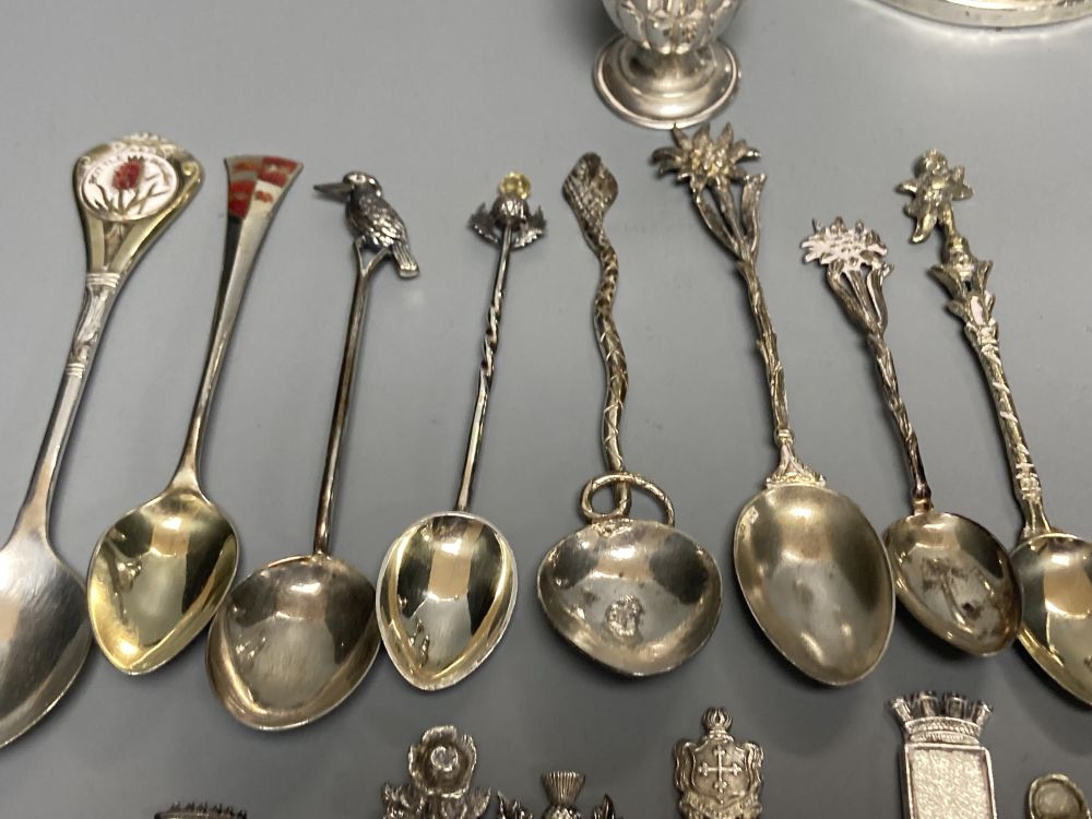 A silver dwarf candlestick, two silver condiments and a group of assorted silver, white metal and plated mainly commemorative spoons,